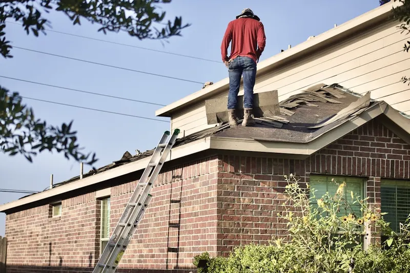 Professional roofer working on a residential roof in Morning View